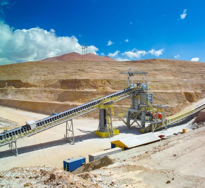 Crushing and conveyor system in a copper mining site with engineered framing.