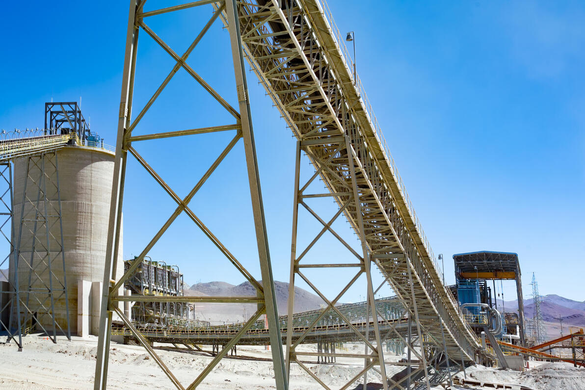 Structural steel trestle supporting elevated conveyors for bulk material transport.
